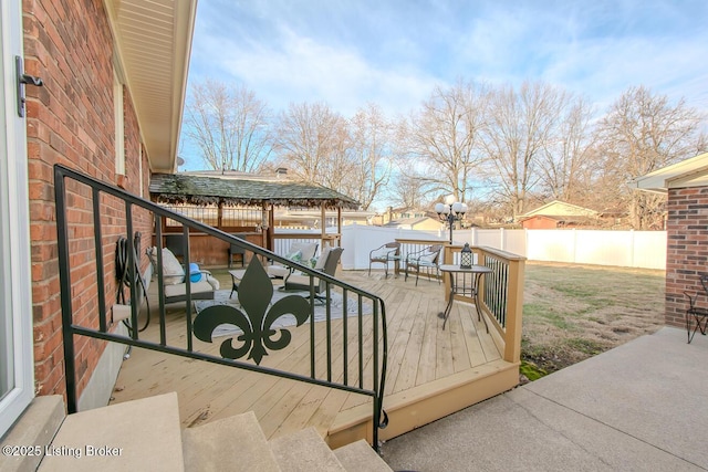 deck featuring a lawn and a fenced backyard