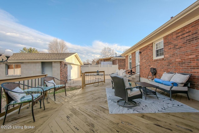 wooden deck with outdoor lounge area and fence