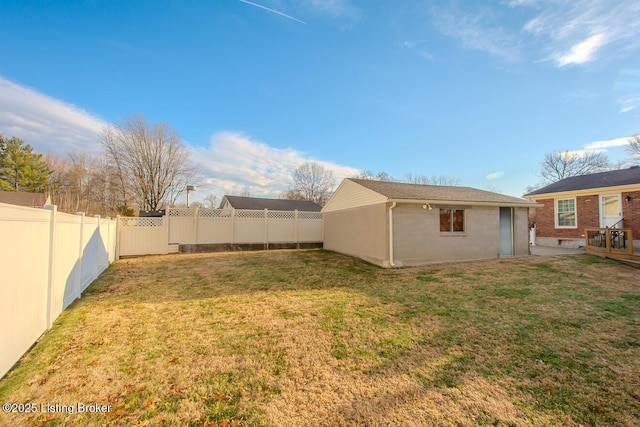 view of yard with a fenced backyard and an outbuilding