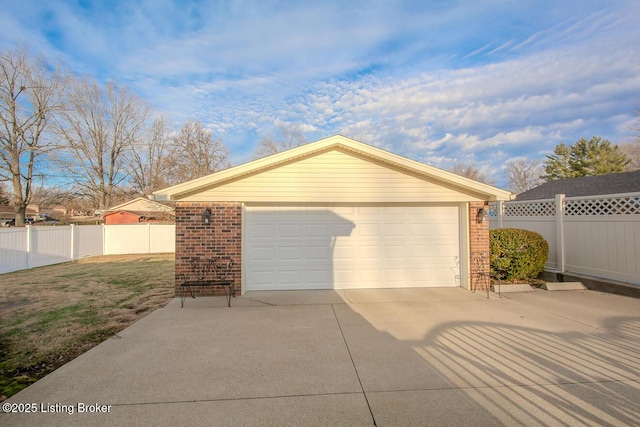 detached garage featuring fence