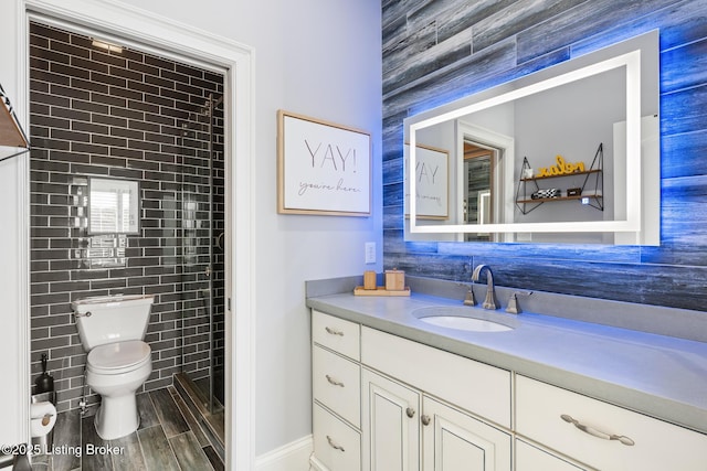 bathroom featuring toilet, tile walls, and vanity