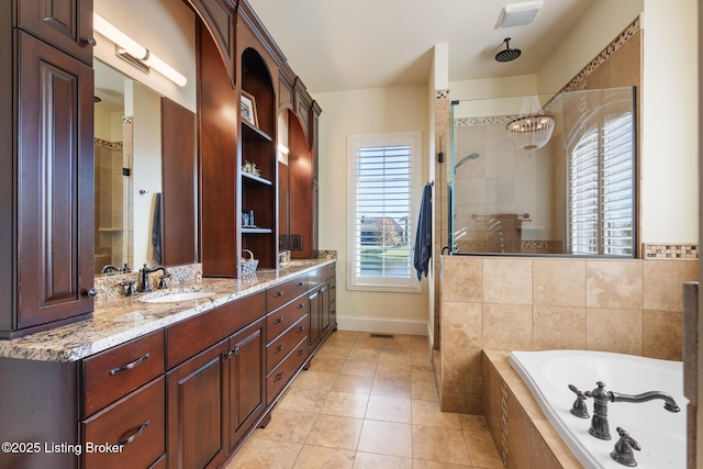 full bath with a garden tub, a sink, tiled shower, tile patterned floors, and double vanity