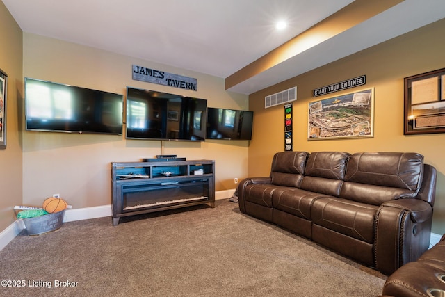 living room with carpet flooring, visible vents, and baseboards