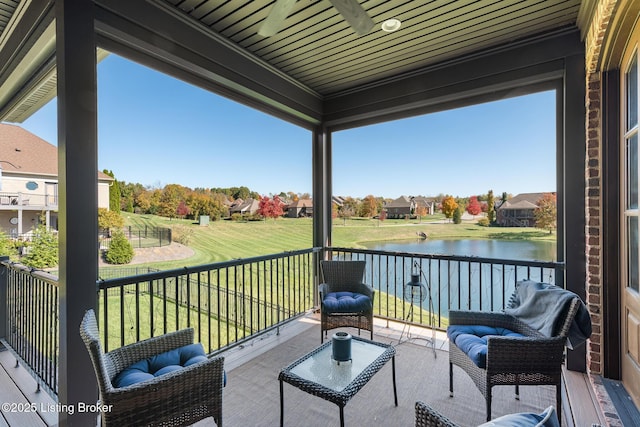 balcony with a residential view and a water view