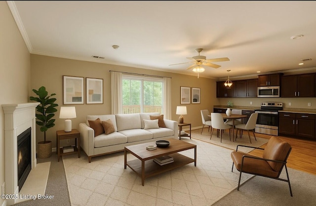 743 N Hite Ave Unit 4, Louisville, KY 40206 - living area featuring crown molding, a glass covered fireplace, a ceiling fan, and baseboards
