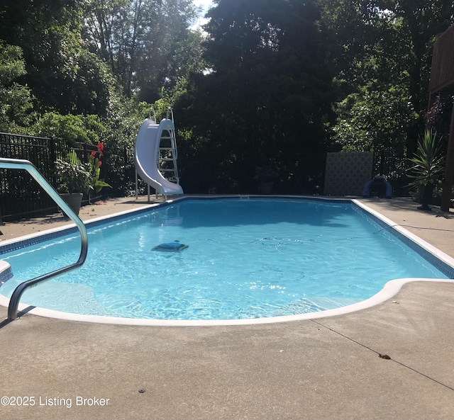 view of pool featuring fence, a fenced in pool, and a water slide