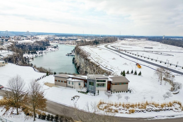 snowy aerial view with a water view