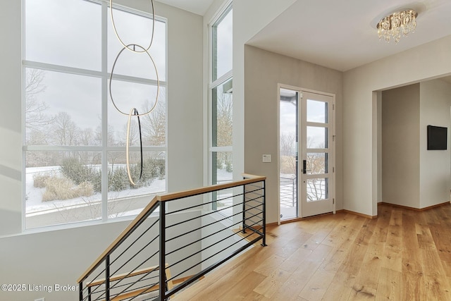 entryway featuring a chandelier and wood-type flooring