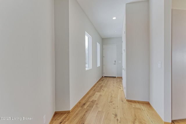 corridor with light wood-style flooring and recessed lighting