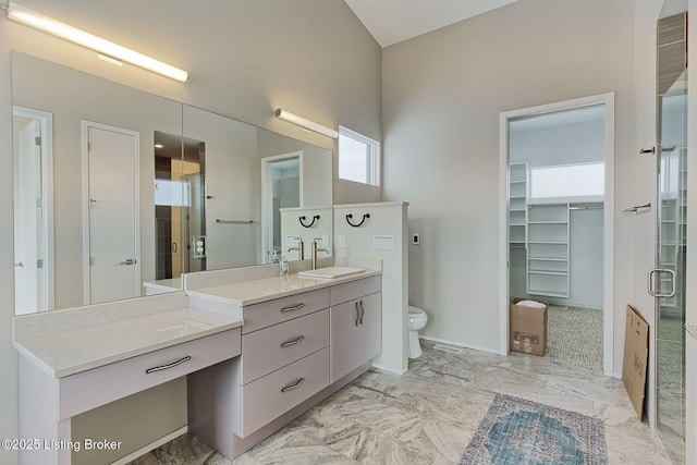 full bath featuring marble finish floor, toilet, a stall shower, vanity, and baseboards