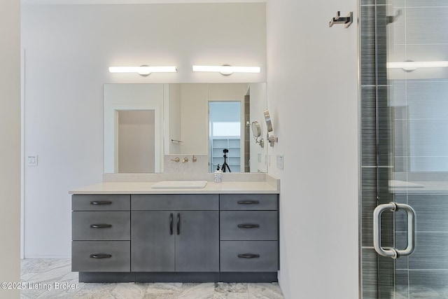 bathroom featuring a stall shower, marble finish floor, and vanity