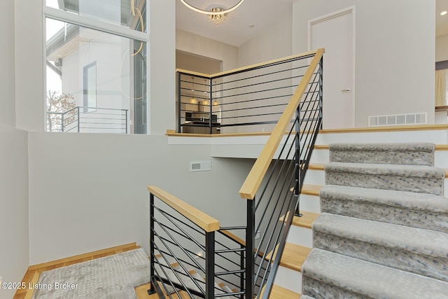 staircase featuring plenty of natural light and visible vents