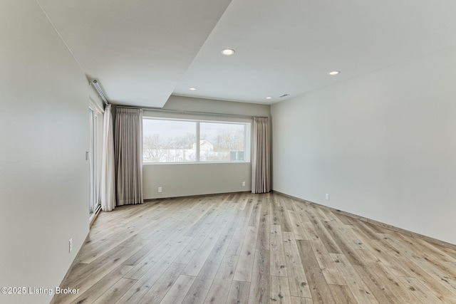 spare room featuring recessed lighting and light wood finished floors