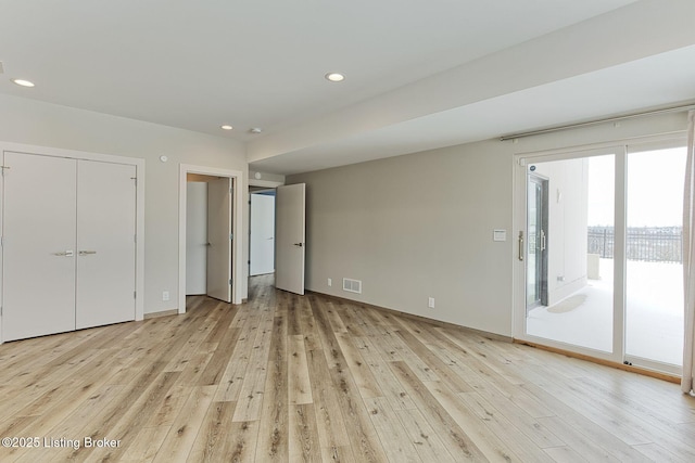 unfurnished bedroom with access to exterior, recessed lighting, visible vents, and light wood-style flooring