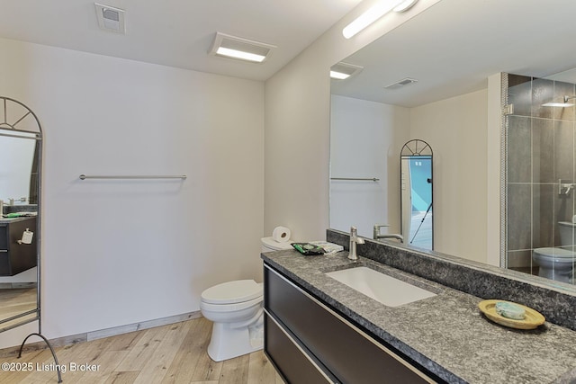 bathroom with visible vents, wood finished floors, and toilet