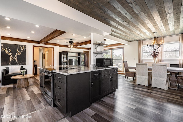 kitchen featuring stainless steel range with electric stovetop, black microwave, dark wood-type flooring, and dark cabinetry