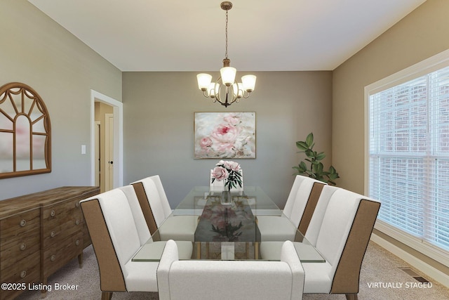 carpeted dining area featuring visible vents and a chandelier