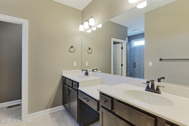 bathroom with a sink, a shower stall, baseboards, and double vanity