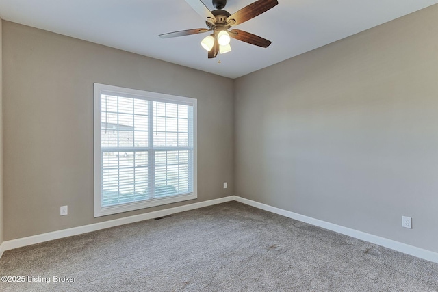 unfurnished room featuring carpet floors, visible vents, ceiling fan, and baseboards