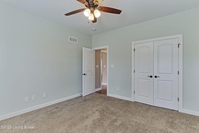 unfurnished bedroom featuring a closet, carpet flooring, visible vents, and baseboards