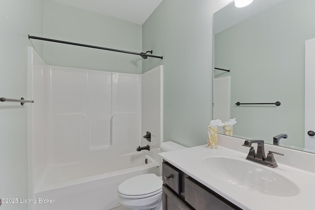 bathroom featuring tub / shower combination, vanity, and toilet