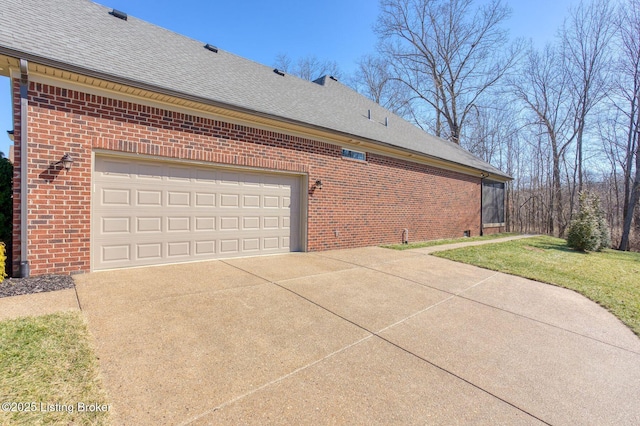 view of home's exterior with a shingled roof, brick siding, driveway, and an attached garage