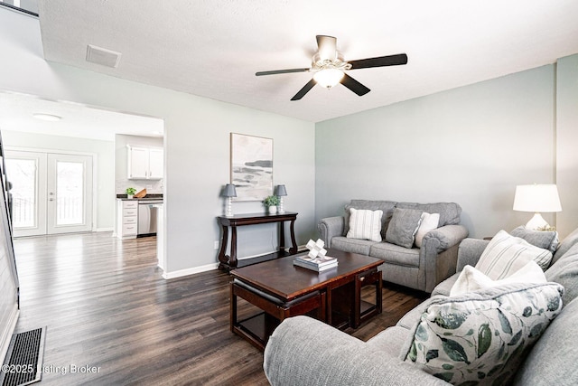 living room with a ceiling fan, baseboards, visible vents, and dark wood-type flooring