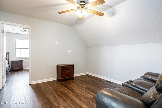 living area with lofted ceiling, dark wood-style floors, baseboards, and visible vents