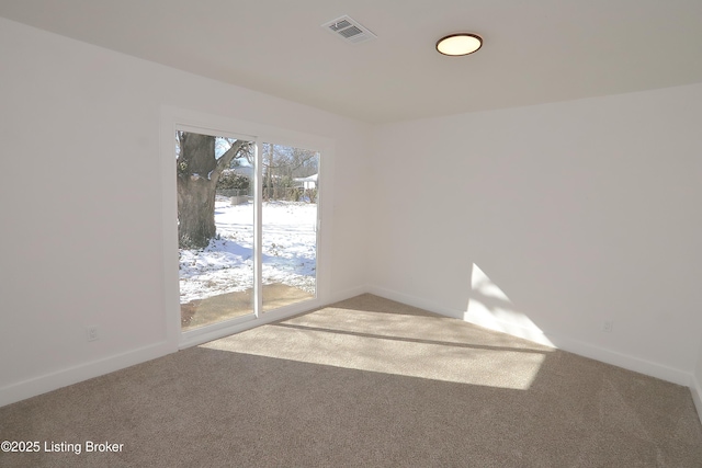 carpeted spare room with baseboards and visible vents