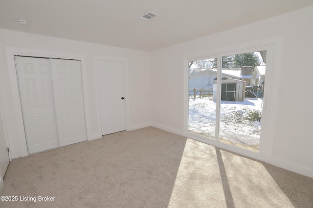 unfurnished bedroom with light carpet and baseboards