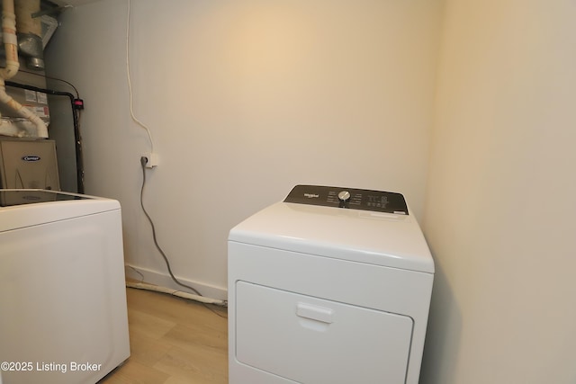 laundry area featuring laundry area, light wood-type flooring, and independent washer and dryer