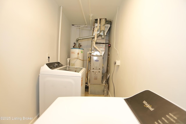 laundry room with water heater, laundry area, and independent washer and dryer