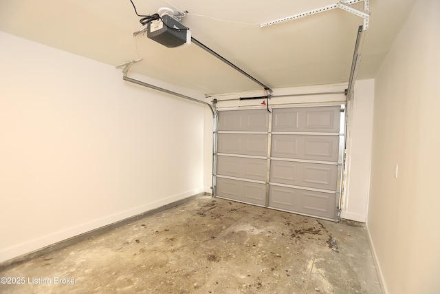 garage featuring a garage door opener and baseboards