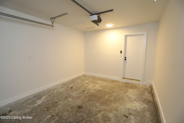 garage featuring a garage door opener and baseboards