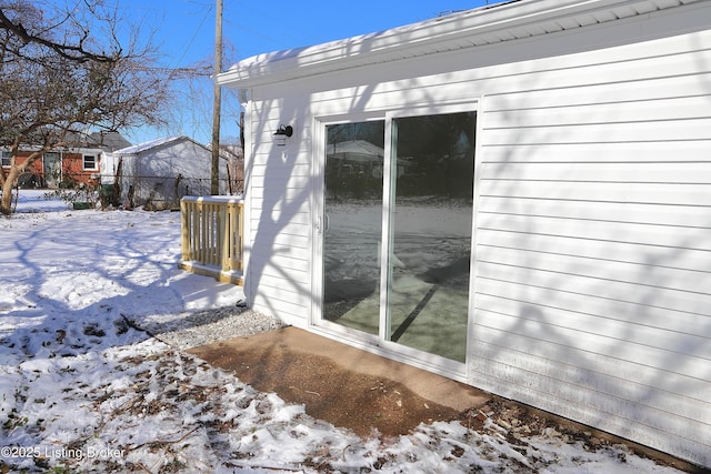 view of snow covered exterior featuring fence