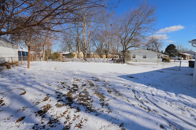 yard layered in snow with fence