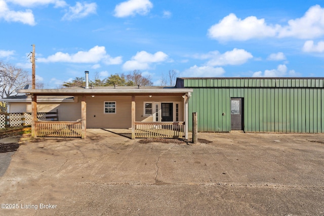 rear view of house with covered porch