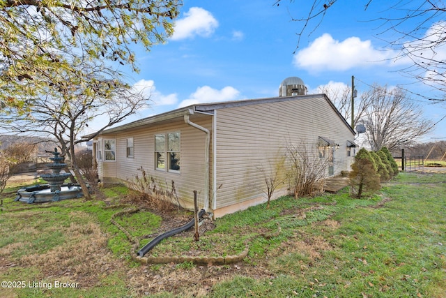 view of property exterior featuring a lawn