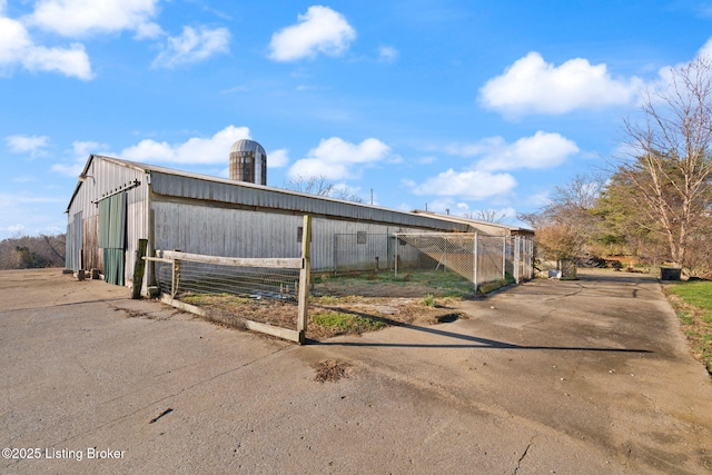 exterior space with a pole building and an outdoor structure