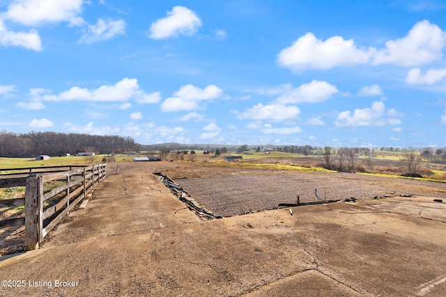 view of yard featuring a rural view and fence