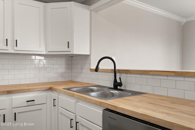 kitchen with black dishwasher, butcher block counters, a sink, and white cabinets