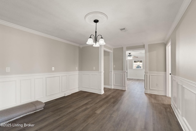 unfurnished dining area with crown molding, visible vents, dark wood-type flooring, and ceiling fan with notable chandelier