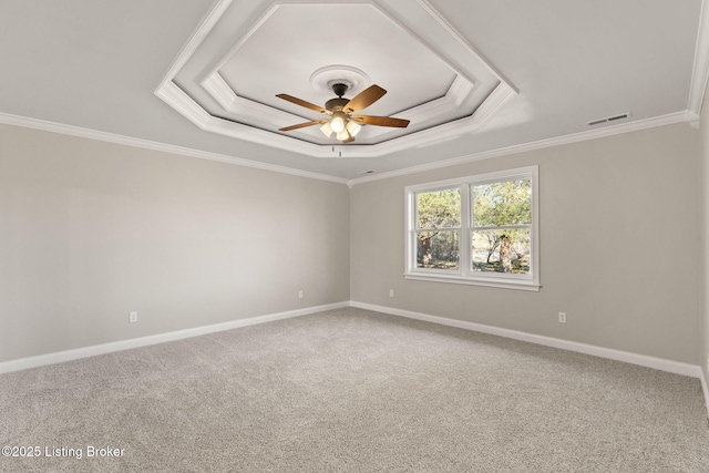 unfurnished room with visible vents, a raised ceiling, a ceiling fan, crown molding, and carpet flooring