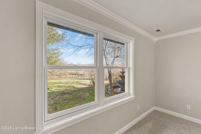 unfurnished room featuring carpet, visible vents, baseboards, and ornamental molding