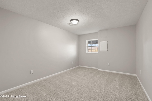 carpeted empty room featuring electric panel, a textured ceiling, and baseboards