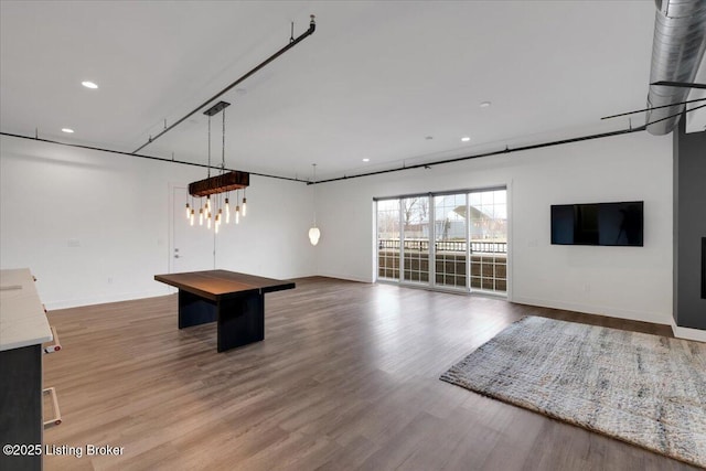 recreation room featuring baseboards, wood finished floors, and recessed lighting