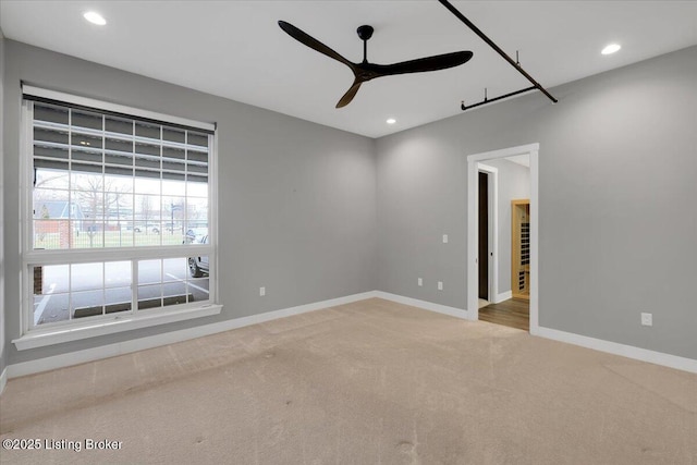 carpeted spare room featuring ceiling fan, recessed lighting, and baseboards