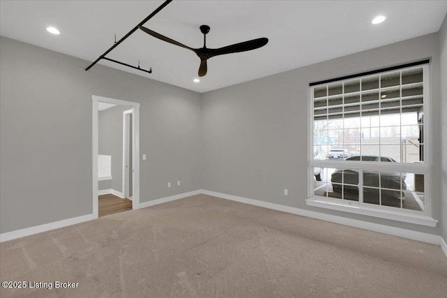 spare room with recessed lighting, carpet, a ceiling fan, and baseboards