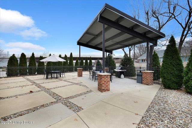 view of patio featuring area for grilling, fence, and a gazebo