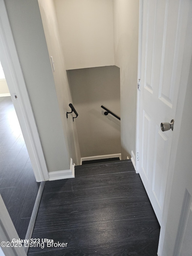 stairs featuring baseboards and wood finished floors